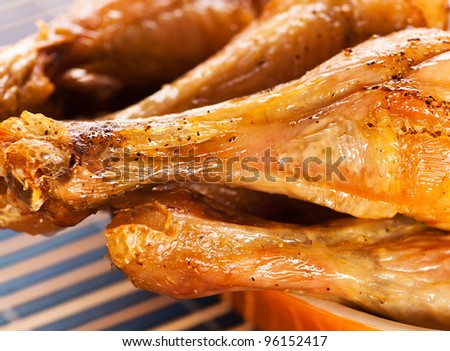 four fried chicken drumsticks tasty dish in yellow on black bamboo napkin