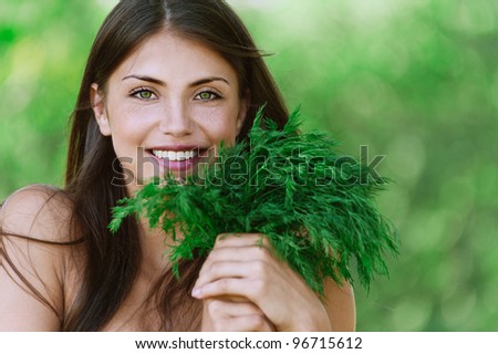 portrait beautiful young woman smiling holding bunch green dill background summer green park