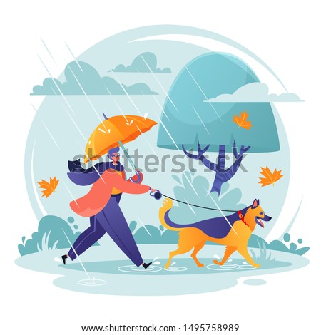 Pet care concept. Man walking his dog in spite of adverse weather conditions. Autumn landscape in rainy day, leaves fall, wind blows. Dog breed German shepherd is happy. His master loves him.