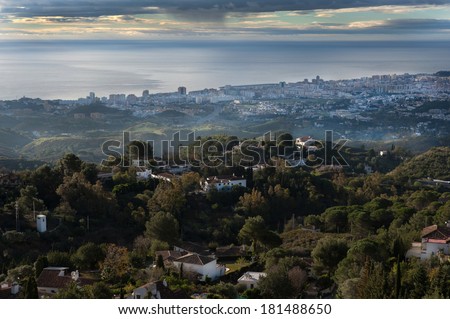A view from behind andfrom high of Fuengirola and the coast with typical spanish villas in the foreground