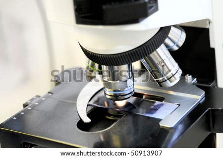 Close up view of microscope lenses platen and slide