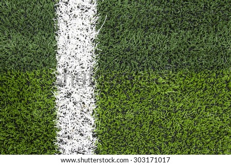 Photo of a green synthetic grass sports field with white line shot