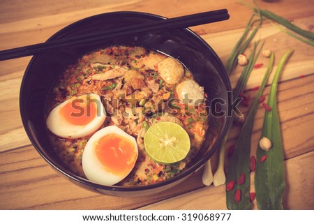 Thai noodle soup in a bowl taste spicy noodle soup and boiled egg vintage color