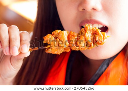 Woman eating barbecued