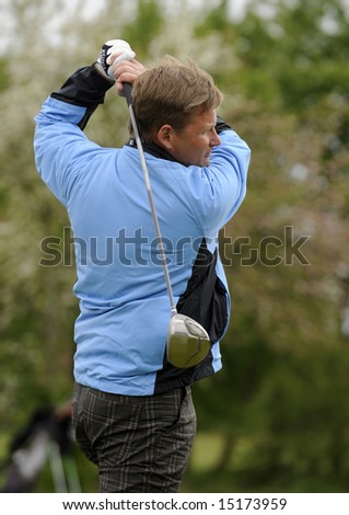 Golf player looking after he strikes a shot