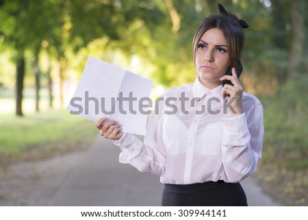 Attractive successful business woman speaks on a cell phone