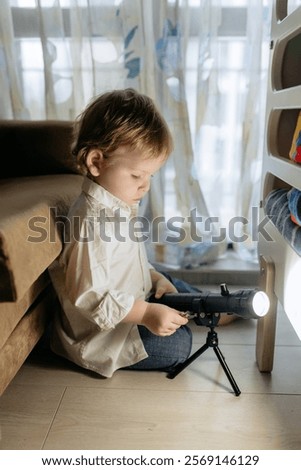 Similar – Image, Stock Photo little colored boy explores the feet of his little brother