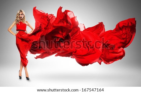 blond woman in windy red dress