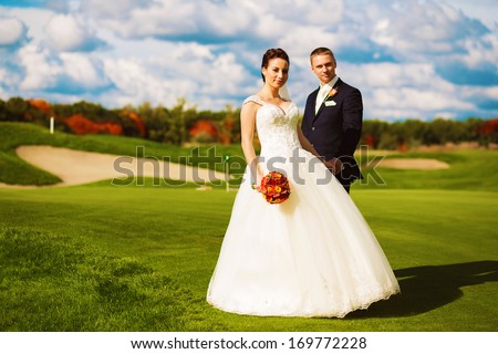 happy married couple on golf field
