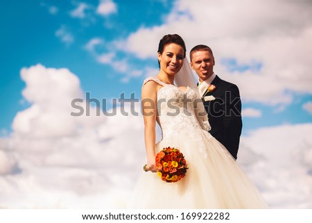 funny bride and groom on clouds background