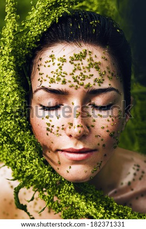 healthy woman with plant on face