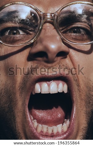angry screaming man in old glasses