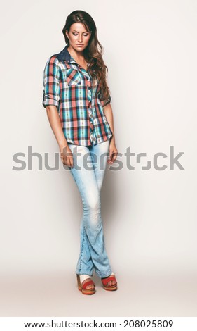 tall woman in check shirt and blue jeans