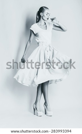 monochrome sexy dancing woman in long skirt in studio