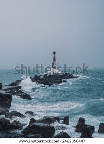 Similar – Foto Bild Einsamer Leuchtturm an felsiger Küste am Morgen