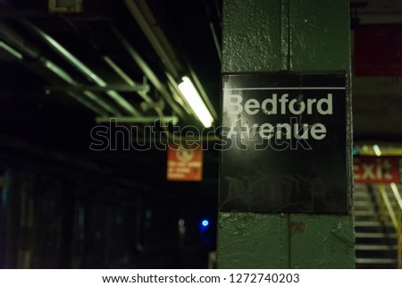 Sign inside the bedford avenue l train station in brooklyn new york  near the williamsburg hipster area where there is a high amount of art and culture. a light is shining on the sign and the subway  Stock fotó © 