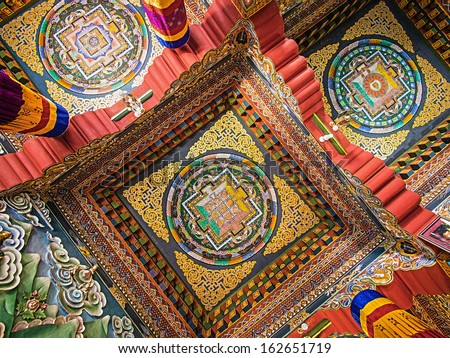 Elaborate, colorful mandalas carved into the ceilings of Bhutanese Buddhist temple in Bodhgaya, Bihar, India.