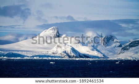 Freezing cold mountain and ice berg landscapes at the Lemaire Channel in Antarctica.