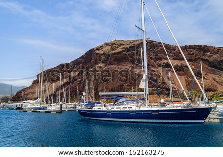 Marina with boats and yachts and volcanic mountain view, Madeira island, Portugal