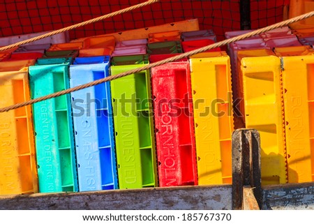 LEBA, POLAND - JUN 10: colourful stack of fish crates on vessel in Leba harbour on 10th June 2013. Leba is home town to many fishermen on Baltic Sea coast.