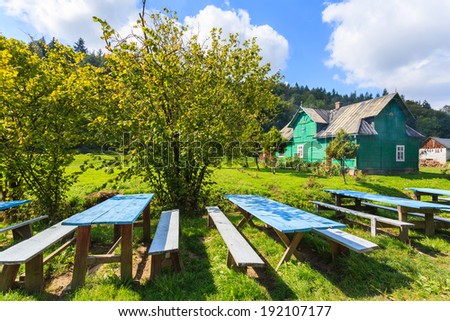 Tables on green field in farming landscape of Skala village near Krakow, Poland