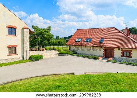 Restaurant building with chairs and tables on sunny terrace in Paczultowice village, Poland