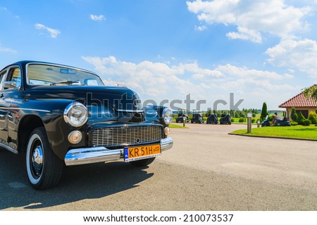 PACZULTOWICE GOLF CLUB, POLAND - AUG 9, 2014: old classic car parks on street in Paczultowice Golf Club. Vintage cars are popular to drive people to weeding ceremony.