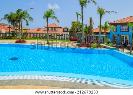 MADEIRA, PORTUGAL - AUG 27, 2013: swimming pool of luxury villa in hotel on coast of Atlantic Ocean. Madeira island is famous for best hotels in Portugal and for climate of eternal spring.