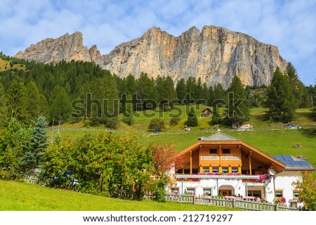 GARDENA PASS, ITALY - SEP 22, 2013: alpine restaurant building near Colfosco village, Dolomites Mountains, Italy. Many tourists visit northern Italy in autumn season and eat in local restaurants.