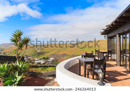 LANZAROTE ISLAND, SPAIN - JAN 16, 2015: Restaurant terrace on Mirador de Los Valles - viewpoint in mountain landscape of Lanzarote, Spain. Canary Islands have tropical climate with sunny weather.