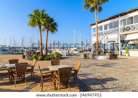 MARINA RUBICON, LANZAROTE ISLAND - JAN 14, 2015: restaurant tables with chairs in Rubicon yacht port. Lanzarote is most northern island in Canary Islands archipelago.