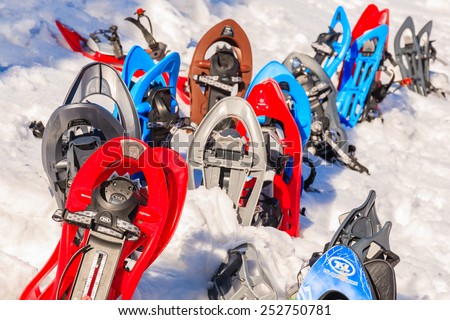 GORCE MOUNTAINS, POLAND - FEB 14, 2015: colorful snowshoes in winter camp located near Turbacz shelter. Every February tourists learn climbing and survival techniques in winter time.