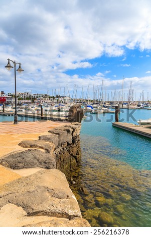 MARINA RUBICON, LANZAROTE ISLAND - JAN 11,2015: View of marina Rubicon with yacht boats mooring. Canary Islands are popular holiday destination due to sunny weather all year round.