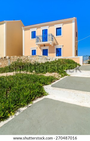 Walkway in Assos town with typical Greek houses built in Venetian style, Kefalonia island, Greece