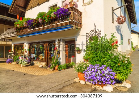 WEISSENSEE LAKE, AUSTRIA - JUL 6, 2015: entrance to guest house decorated with flowers on shore of Weissensee lake in summer season, Carinthia land, Austria.