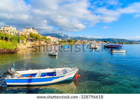 Greek fishing boats in sea bat near port at sunrise time on Samos island, Greece