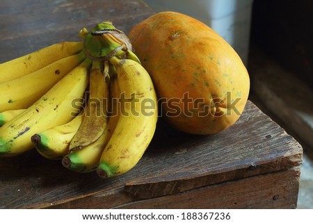 banana and papaya on the old wooden table