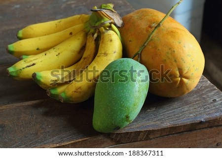 banana,mango and papaya on the old wooden table