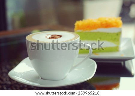 Mocha in white coffee cup and Foythong Cake or Gold Egg Yolks Thread Cake in the Coffee Shop, vintage tone