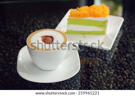 Mocha in white coffee cup and Foythong Cake or Gold Egg Yolks Thread Cake in the Coffee Shop, retro and vintage tone