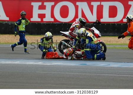 Buriram, Thailand - August 30, 2015: Asia Road Racing Championship 2015. Rescue teams helped a driver who has an accident during the match round 4 in chang international circuit.