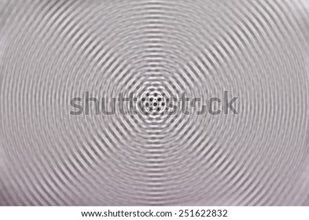 Radial spin blurred black and white polka dot fabric background.