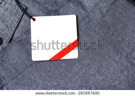 Dark background with white paper pants label/Pants label.
