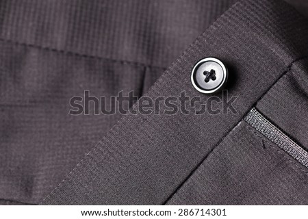 black button on black pants men suite.