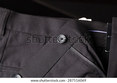 black button on black pants men suite.
