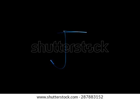 Long exposure small neon lights letter J texture. Abstract colorful neon light.