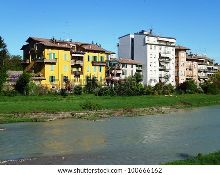 Houses with gardens along the Parma river in the city Parma in Italy