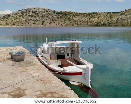 Fish traps of a small fishing boat in the bay of the island Levrnaka in the Kornati national park in Croatia