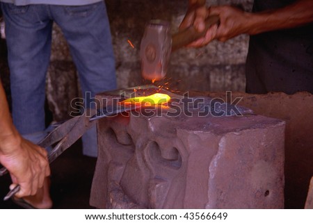 Hot iron at the anvil of a black smith