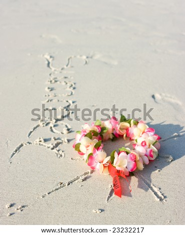 Hawaii flowers lying on the sand like a sun